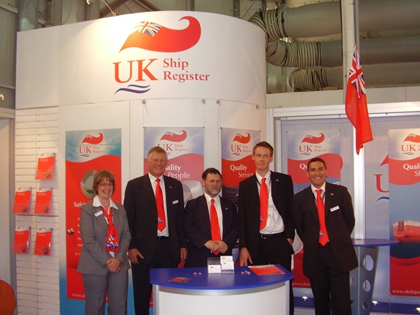Five people at a conference stand for the UK Ship Register. 