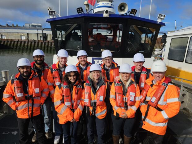 Vinu, Immanuel and Lisa pictured onboard a vessel in safety gear with the Kincardine offshore wind farm team.